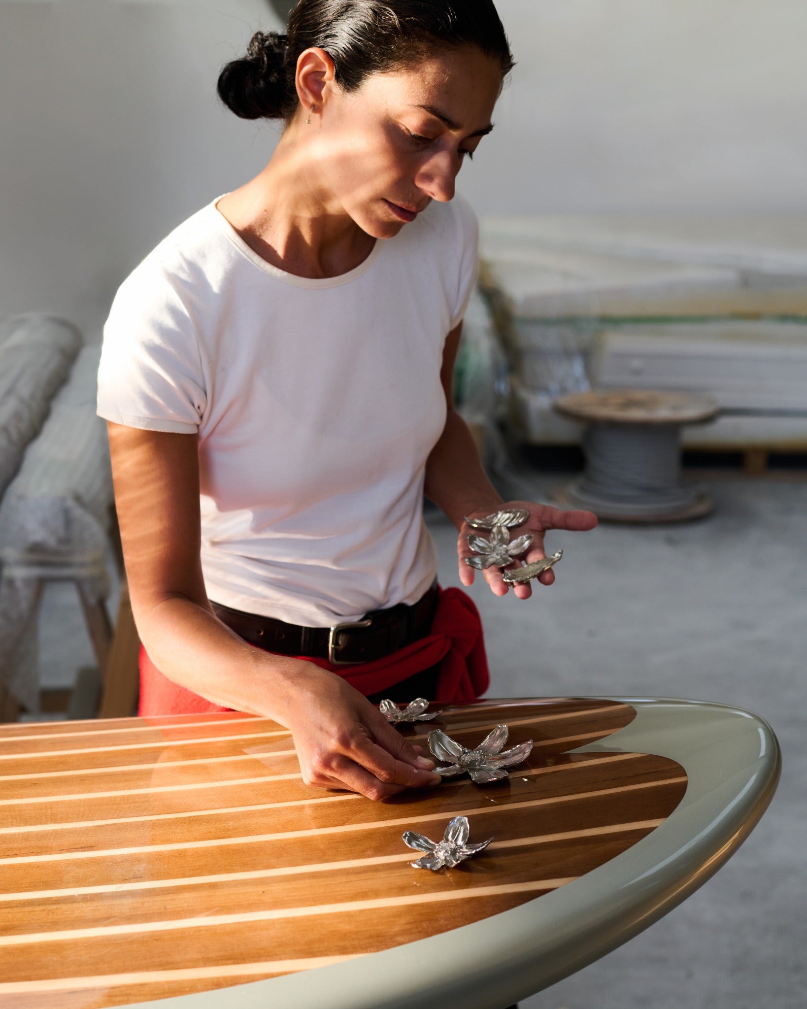 Arranging the botanical sculptures on the wood veneer deck