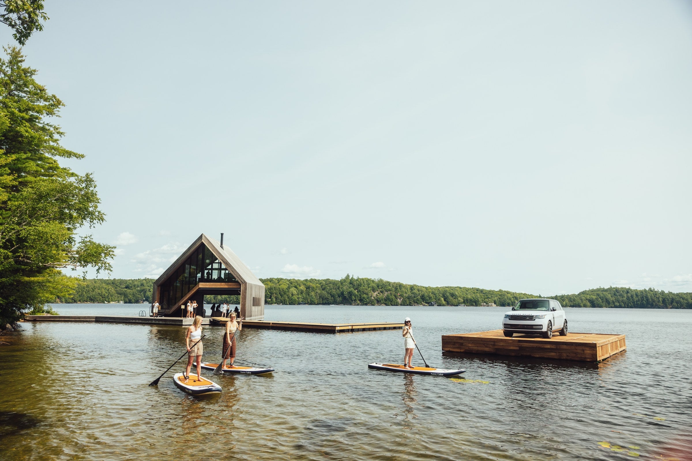 Guests on Newport paddleboards at Range Rover House